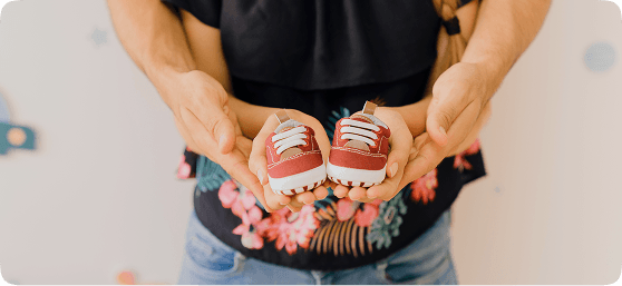Mother holding baby shoes